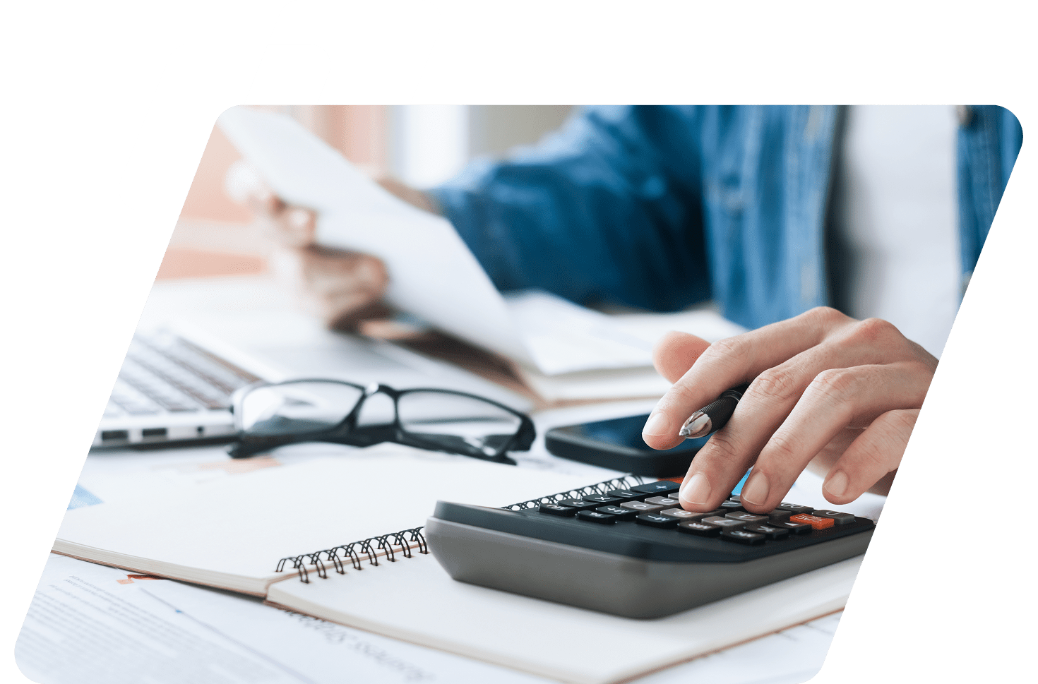 Person using calculator at a desk.